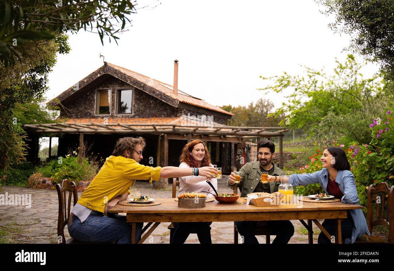 friends spending the day in a country house while eating and having fu Stock Photo