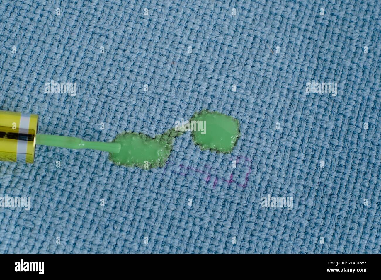 Remove nail polish stains on fabrics, brush spilled green nail polish