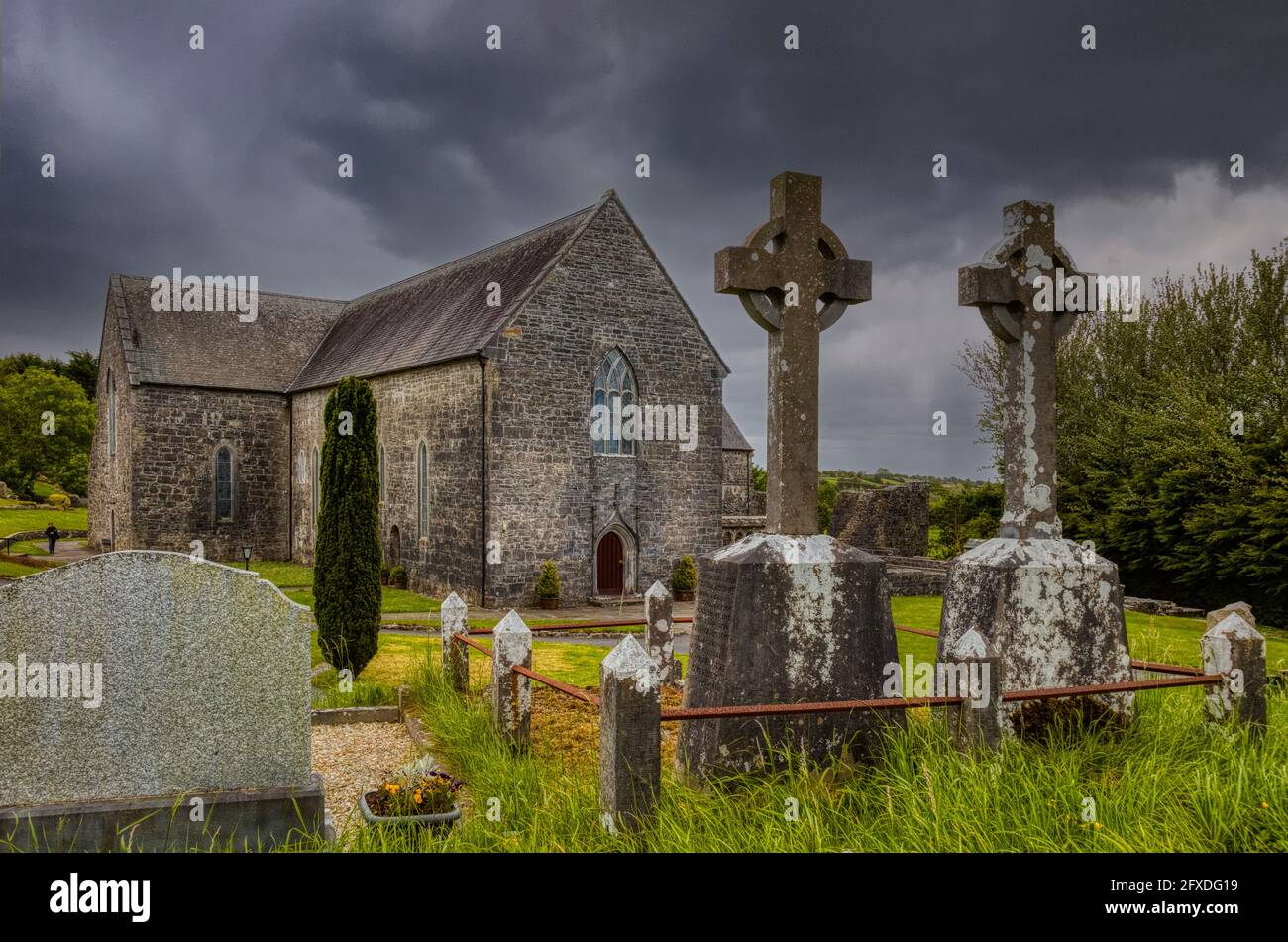 Dark stormy sky over an old graveyard and ruins of a stone cchurch Stock Photo