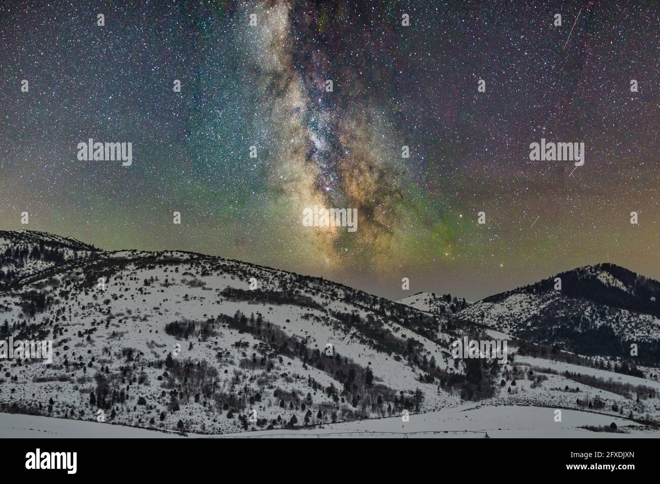Beautiful view of the Milky Way Galaxy over a mountainous landscape ...