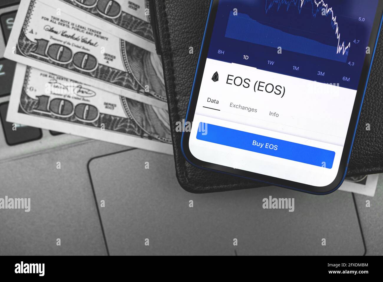 EOS crypto currency on the screen of mobile phone, online banking concept, investment and finance background with wallet and dollar Stock Photo
