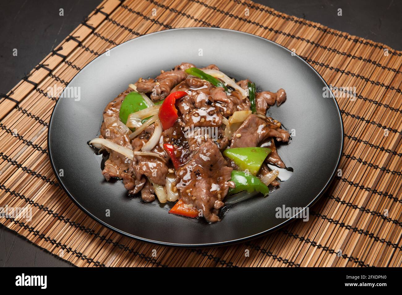 Beef in black bean sauce with red and green peppers at a Korean