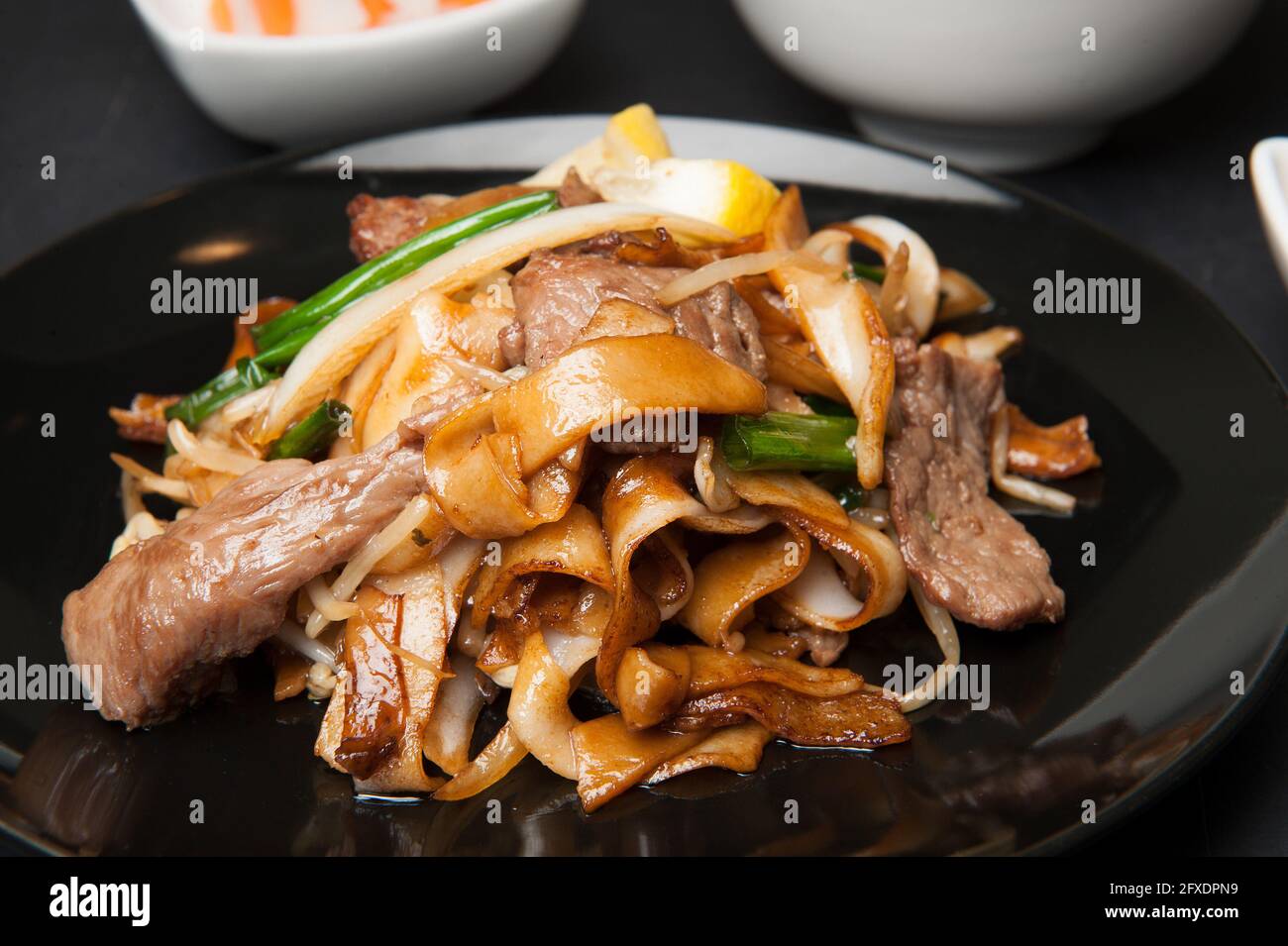 Beef in black bean sauce with flat rice noodles at a Korean restaurant