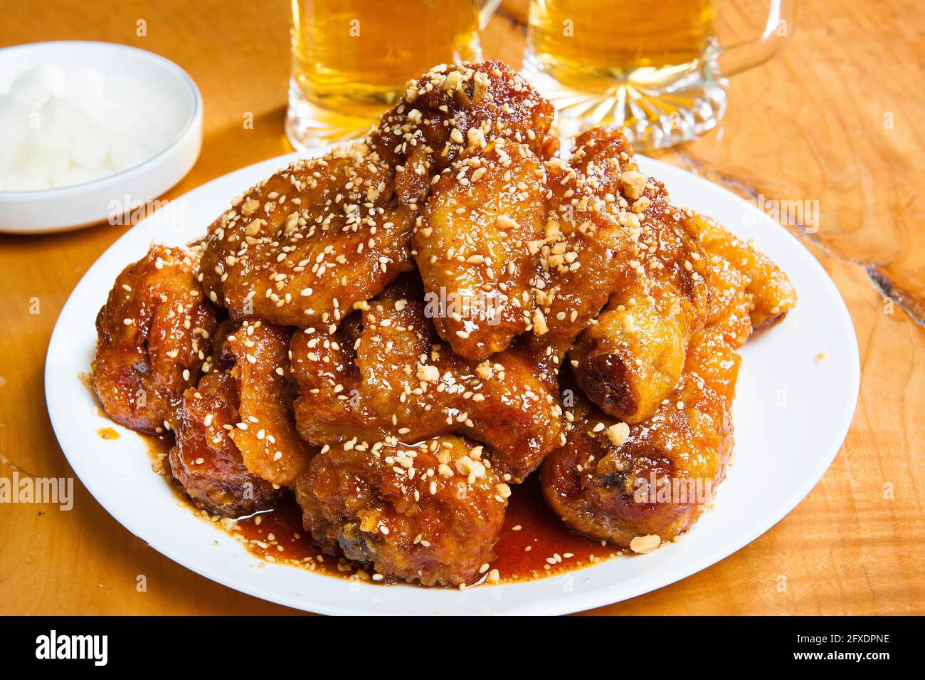 Korean spicy chicken wings with glasses of beer. Stock Photo