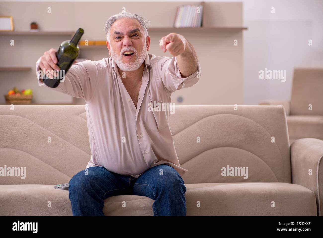 Aged man drinking alcohol at home Stock Photo Alamy