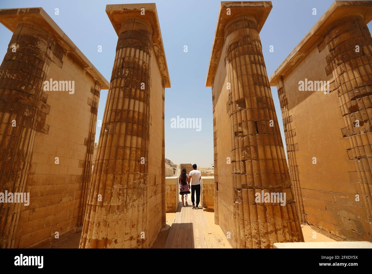 Cairo, Egypt. 26th May, 2021. Tourists visit the Step Pyramid complex in the Saqqara necropolis near the capital Cairo, Egypt, May 26, 2021. The Step Pyramid, a UNESCO World Heritage Site, was designed and built by the architect Imhotep in the 27th century BC during the Third Dynasty to hold the mummy of Pharaoh Djoser. Credit: Sui Xiankai/Xinhua/Alamy Live News Stock Photo