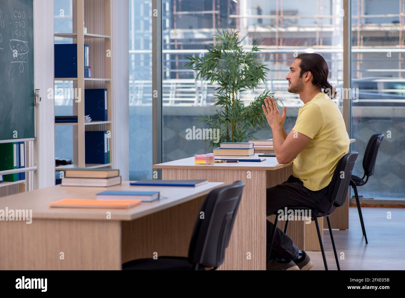 Male student sitting in the classroom Stock Photo - Alamy