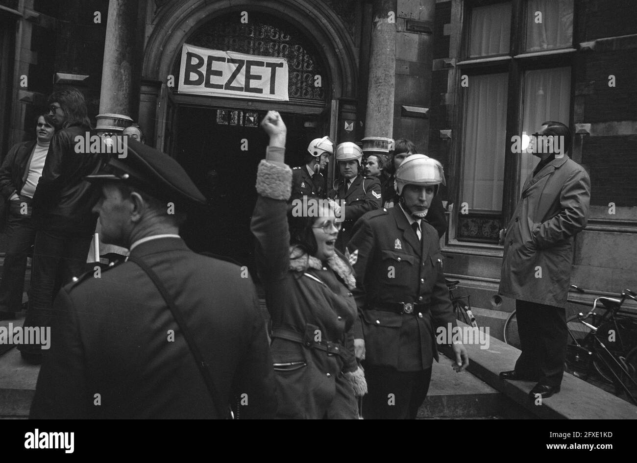 Students removed from Utrecht University, helmeted policemen lead girl out, February 15, 1973, POLICE AGENTS, STUDENTS, girls, universities, The Netherlands, 20th century press agency photo, news to remember, documentary, historic photography 1945-1990, visual stories, human history of the Twentieth Century, capturing moments in time Stock Photo