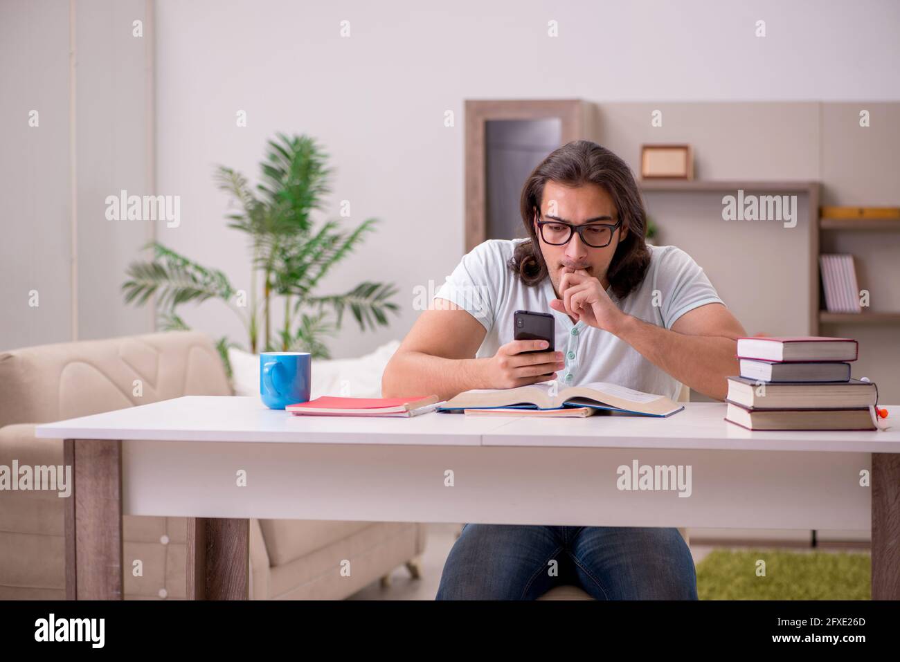 Young student preparing for exams at home Stock Photo - Alamy