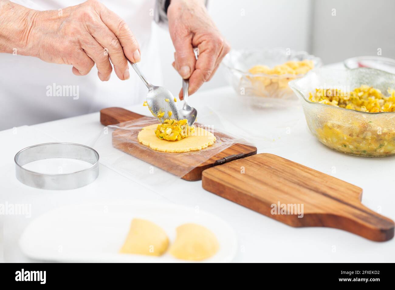 Senior woman filling an empanada a traditional dish from el Valle del Cauca in Colombia Stock Photo