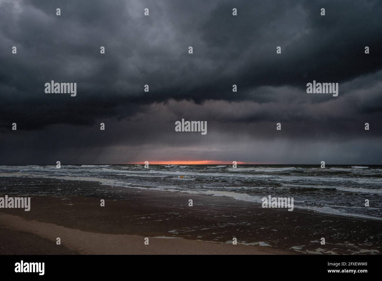 Dramatic dark storm clouds over the ocean after the sunset Stock Photo ...