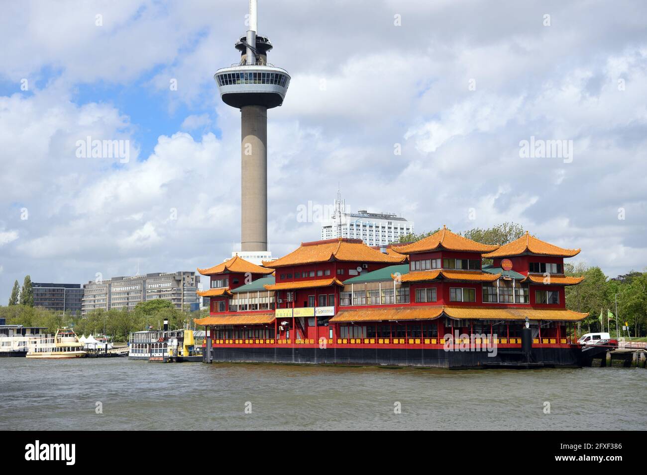 Rotterdam, Netherlands. 21st May, 2021. The Euromast observation tower, designed by architect Huig Maaskant, is located behind the Amazing Oriental Rotterdam Parkhaven. The tower was opened in the 1960s for the garden exhibition Floriade. The Chinese-style building houses restaurants, a hotel and a supermarket. Credit: Soeren Stache/dpa-Zentralbild/dpa/Alamy Live News Stock Photo