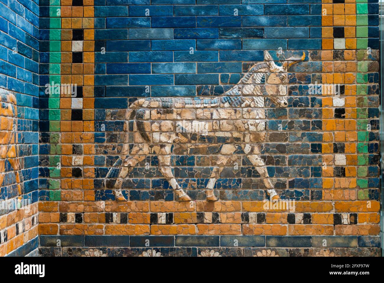 walking Aurochs symbol of Hadad deity on blue ceramic wall from ancient Babylon Stock Photo