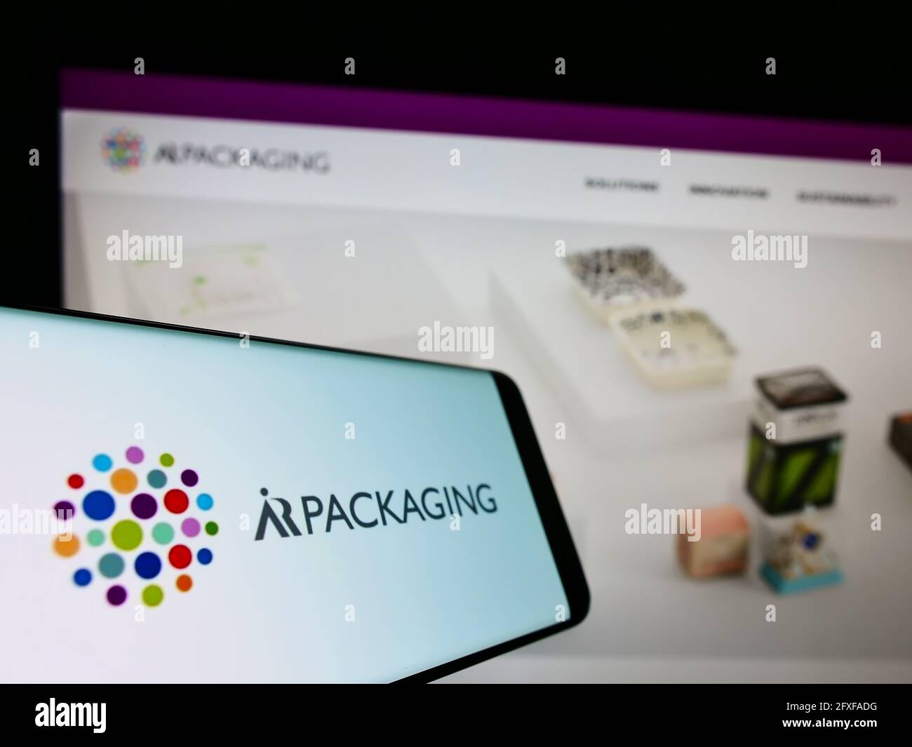 Cellphone with logo of Swedish company AR Packaging Group AB on screen in front of business website. Focus on center-left of phone display. Stock Photo