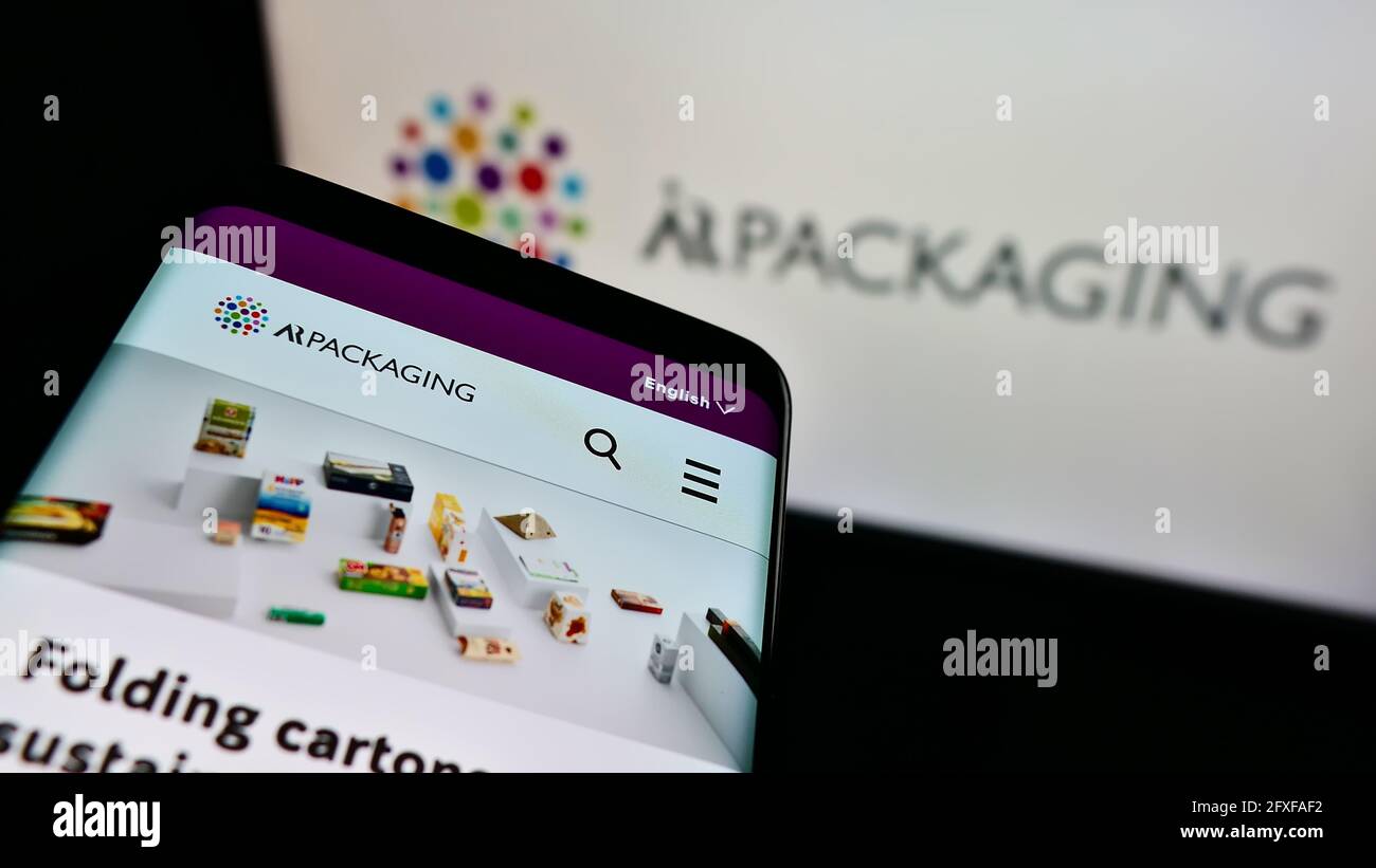 Mobile phone with website of Swedish company ÅR Packaging Group AB on screen in front of business logo. Focus on top-left of phone display. Stock Photo