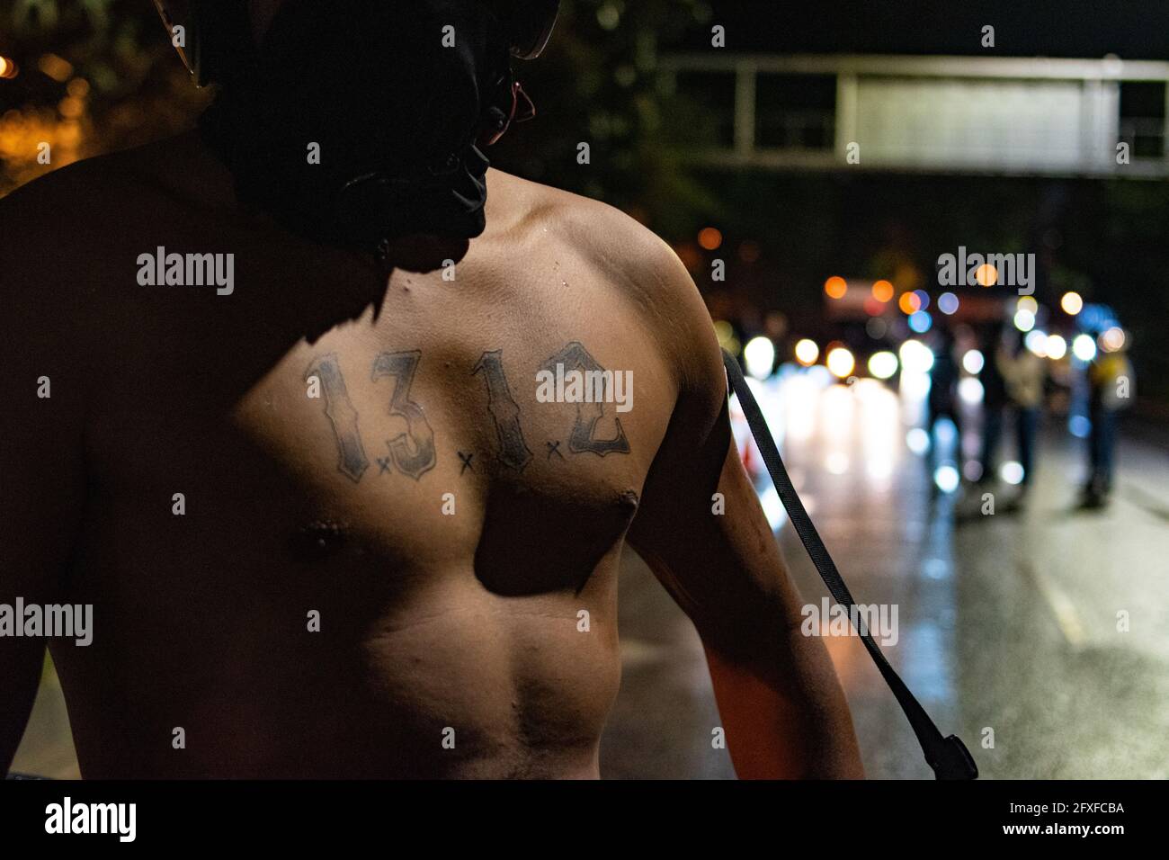 Medellin, Colombia. 26th May, 2021. A demonstrator shows a tattoo with the number '1312' which simbolizes the acronym against police (ACAB) in a performing arts demonstration as artists and demonstrators protested against the government of president Ivan Duque Marquez and the abuse of force by police that leads to at least 40 dead across the country since the nation wide antigovernment protests started. In Medellin, Colombia on May 26, 2021. Credit: Long Visual Press/Alamy Live News Stock Photo