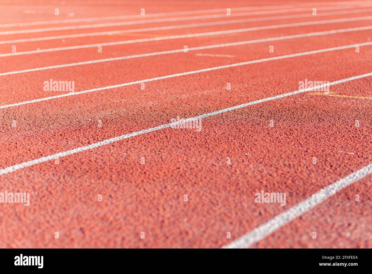 Part Red plastic track in the outdoor track and field stadium.Closeup. Stock Photo