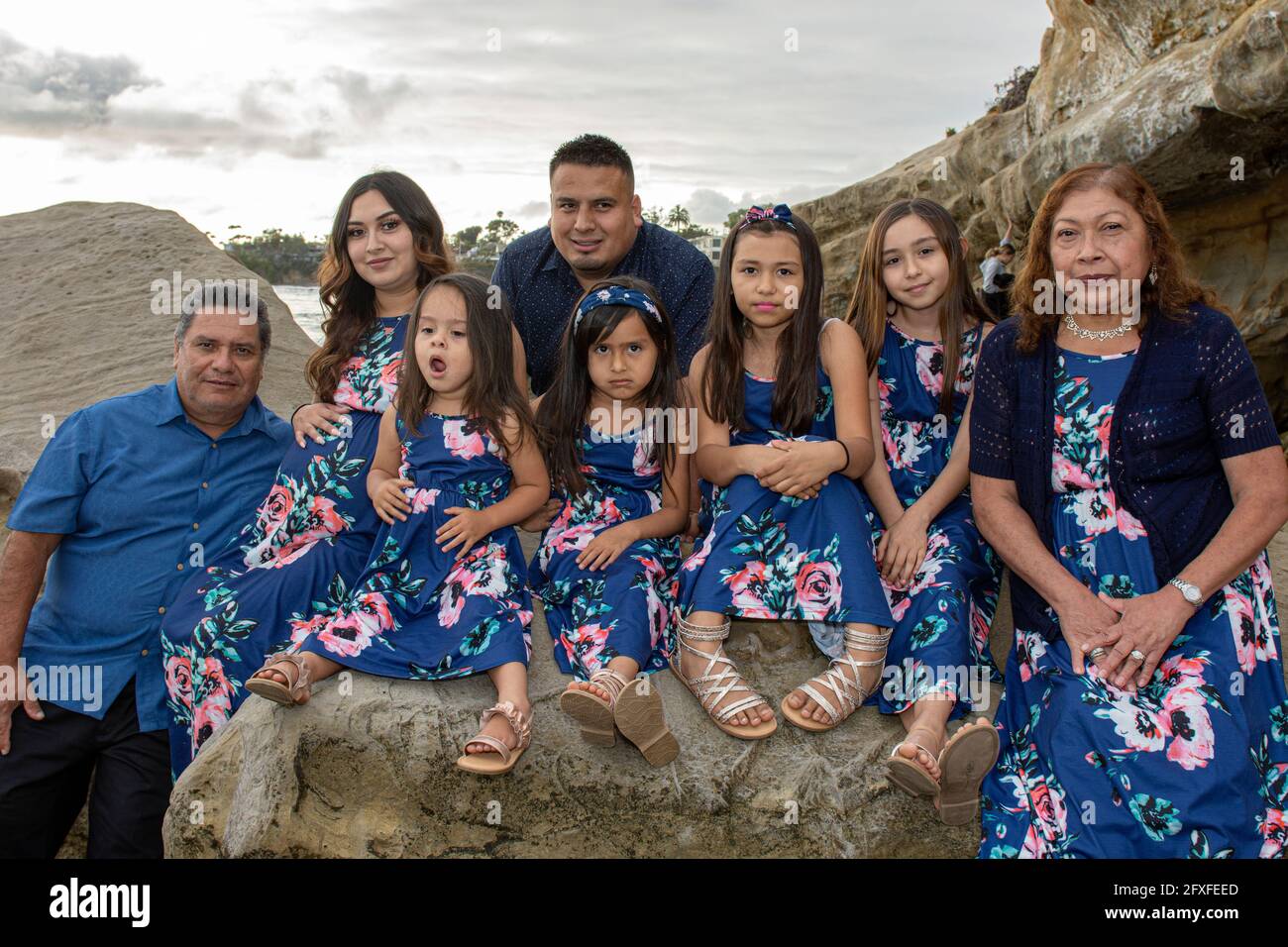 A 32 Year Old Latina Woman With Her Family Who Are Taking Part In Her Maternity Photo Shoot 