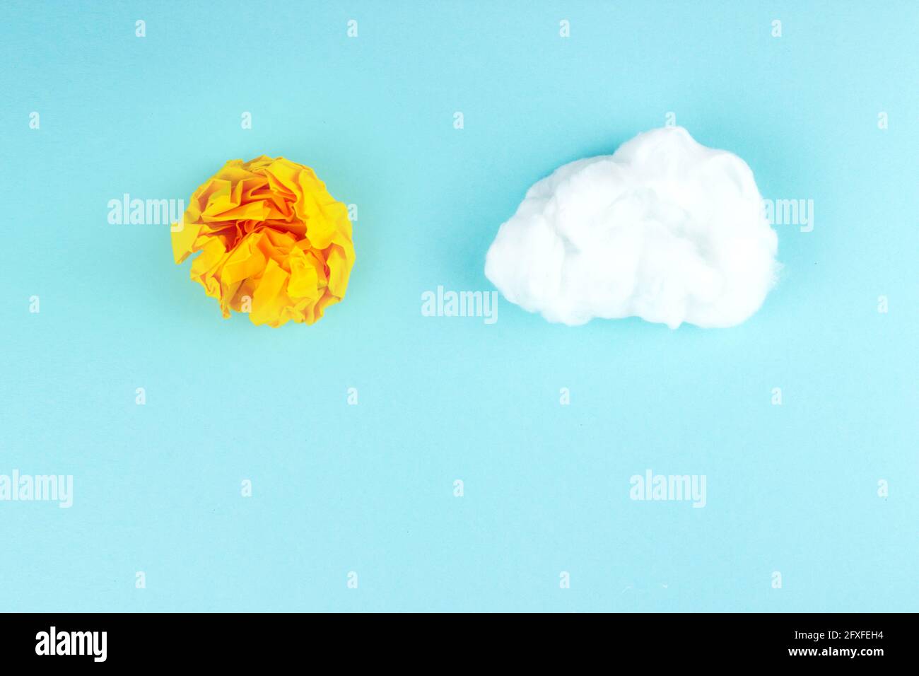 Yellow crumpled paper ball. Business creativity, idea concept. Shining sun concept. Stock Photo