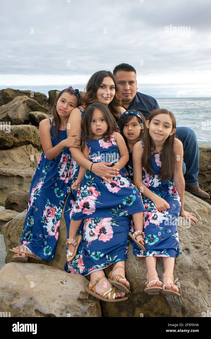 A 32 Year Old Latina Woman With Her Family Who Are Taking Part In Her Maternity Photo Shoot 