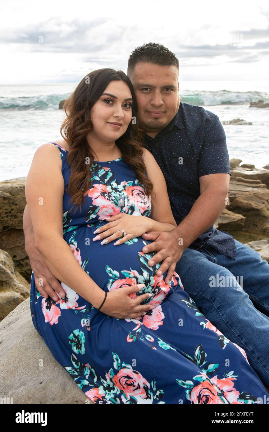 A 32 Year Old Latina Woman With Her Family Who Are Taking Part In Her Maternity Photo Shoot 