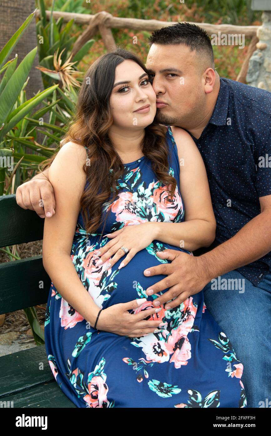 A 32 Year Old Latina Woman With Her Family Who Are Taking Part In Her Maternity Photo Shoot 