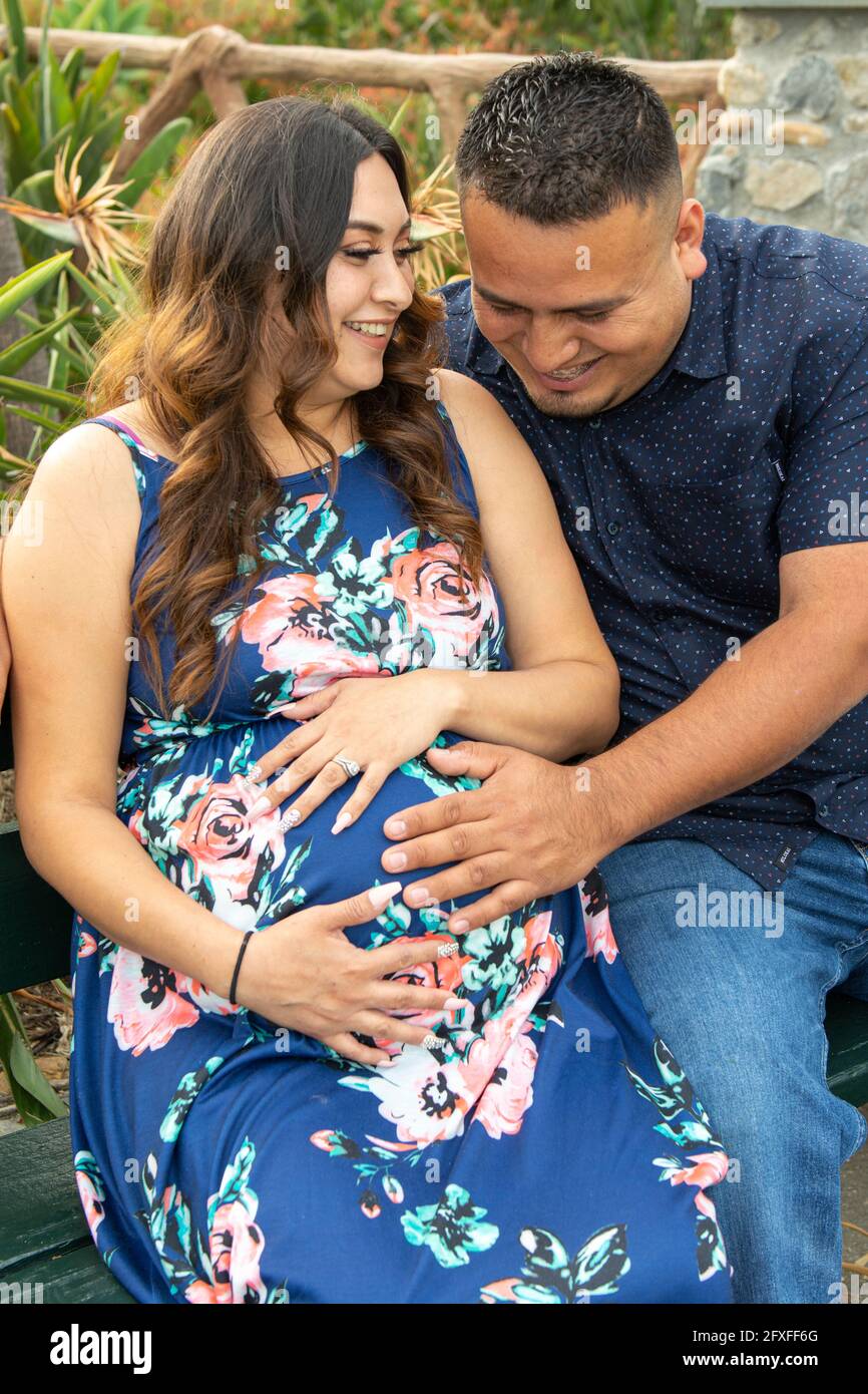 A 32 Year Old Latina Woman With Her Family Who Are Taking Part In Her Maternity Photo Shoot 