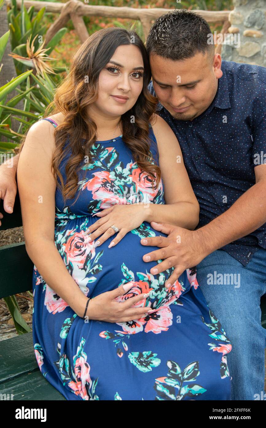 A 32 Year Old Latina Woman With Her Family Who Are Taking Part In Her Maternity Photo Shoot 
