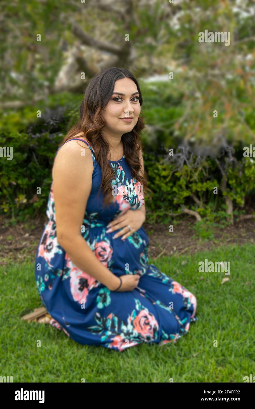 A 32 Year Old Latina Woman With Her Family Who Are Taking Part In Her Maternity Photo Shoot 