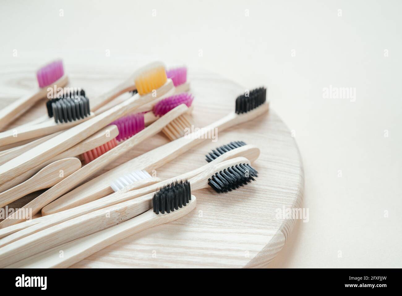 Colorful eco friendly bamboo toothbrushes on wooden tray, dental care ...