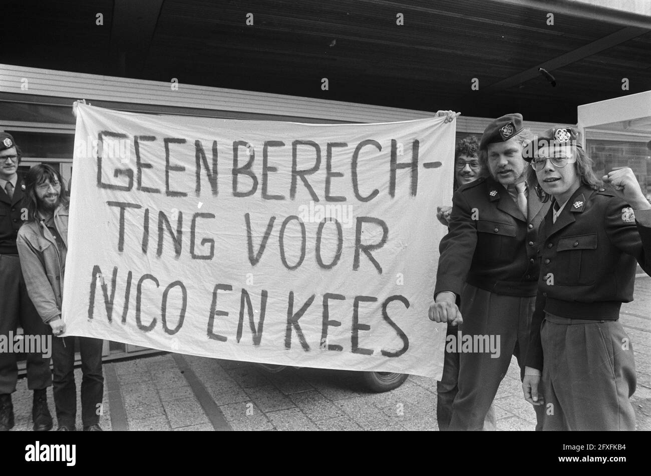 Two military men in front of Arnhem court-martial because of strike in Hohne ( West Germany ); Nico Bruijstens (with glasses) and Kees van Dijk with banner, June 13, 1974, MILITARY, Strikes, The Netherlands, 20th century press agency photo, news to remember, documentary, historic photography 1945-1990, visual stories, human history of the Twentieth Century, capturing moments in time Stock Photo