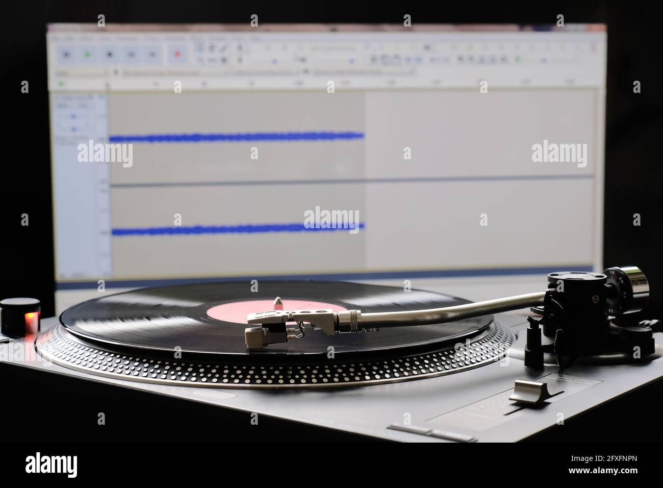 Vinyl record and turntable during analog to digital audio conversion using computer software