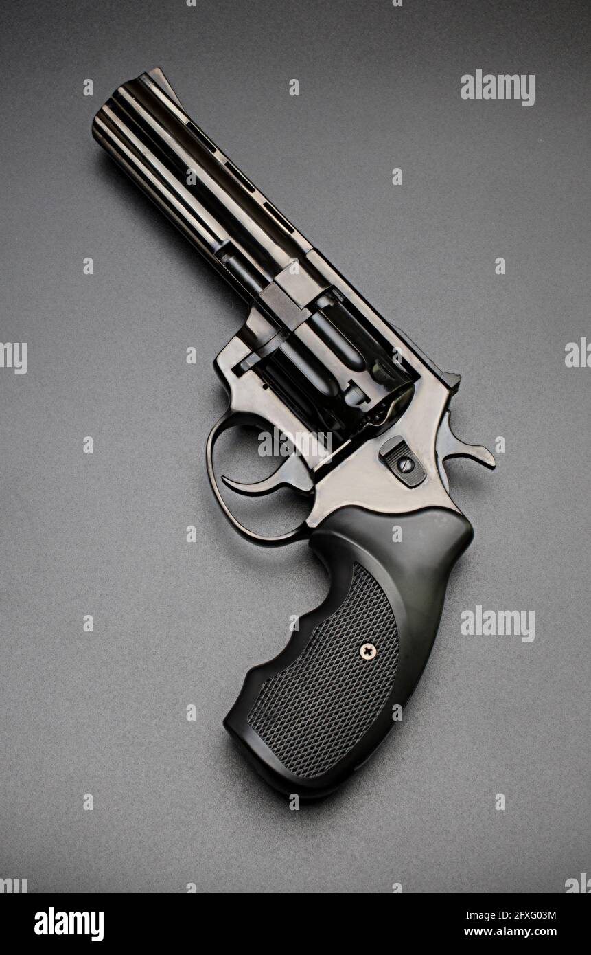 black shiny revolver on black background Stock Photo