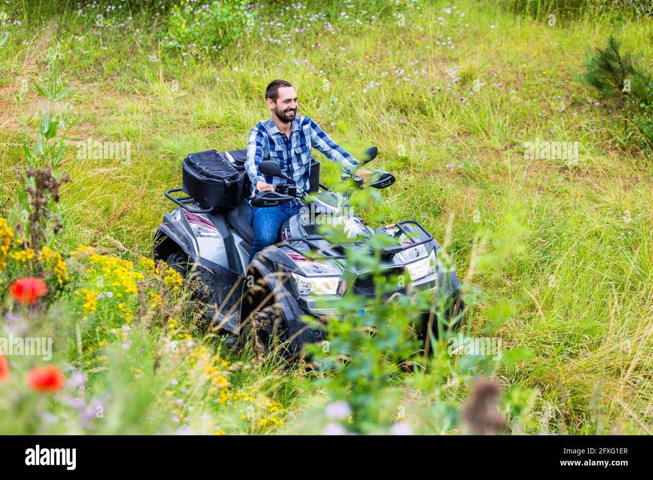 Man driving off-road with quad bike or ATV Stock Photo - Alamy