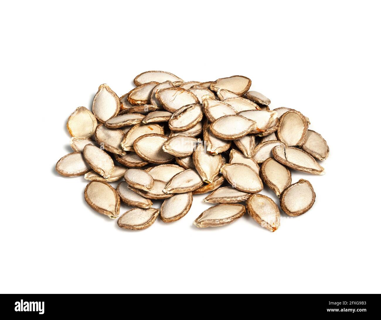handful of unhusked Pumpkin seeds closeup on white background Stock Photo