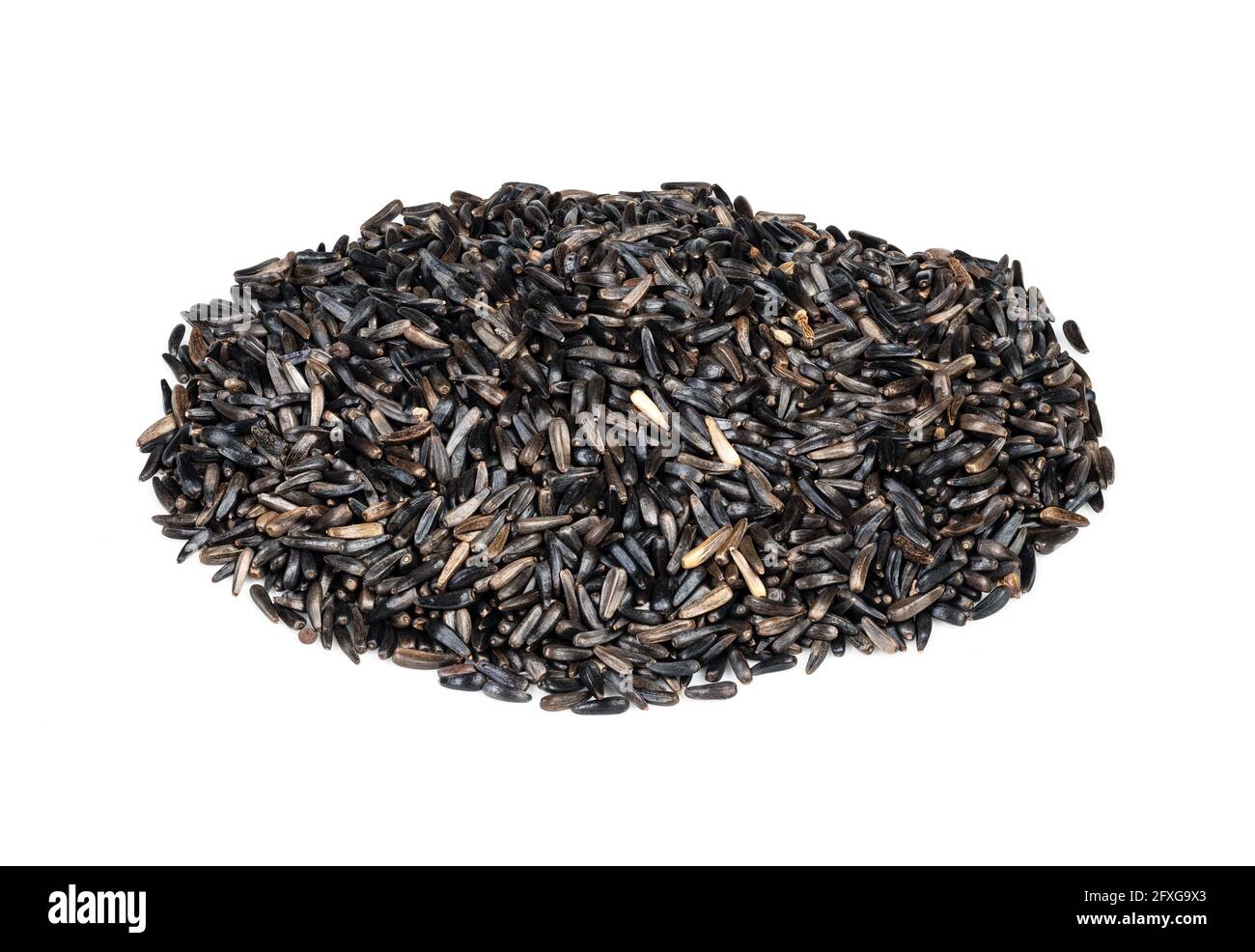 pile of niger seeds (Guizotia Abyssinica) closeup on white background Stock Photo