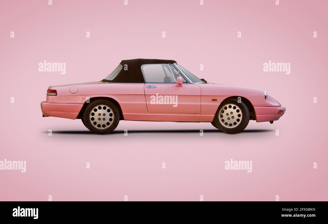 Classic Italian Sport car isolated on pink background Stock Photo - Alamy