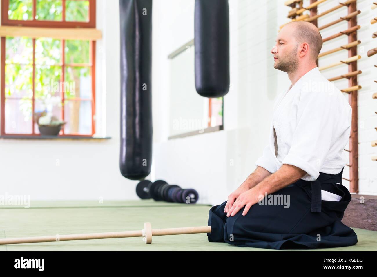 Man at Aikido martial arts training with wooden sword Stock Photo