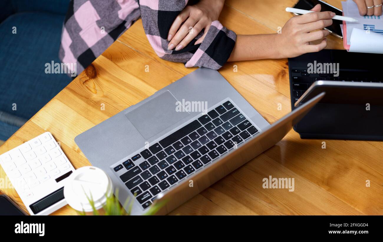 Top view of comfortable workspace with laptop, calculator and two ...