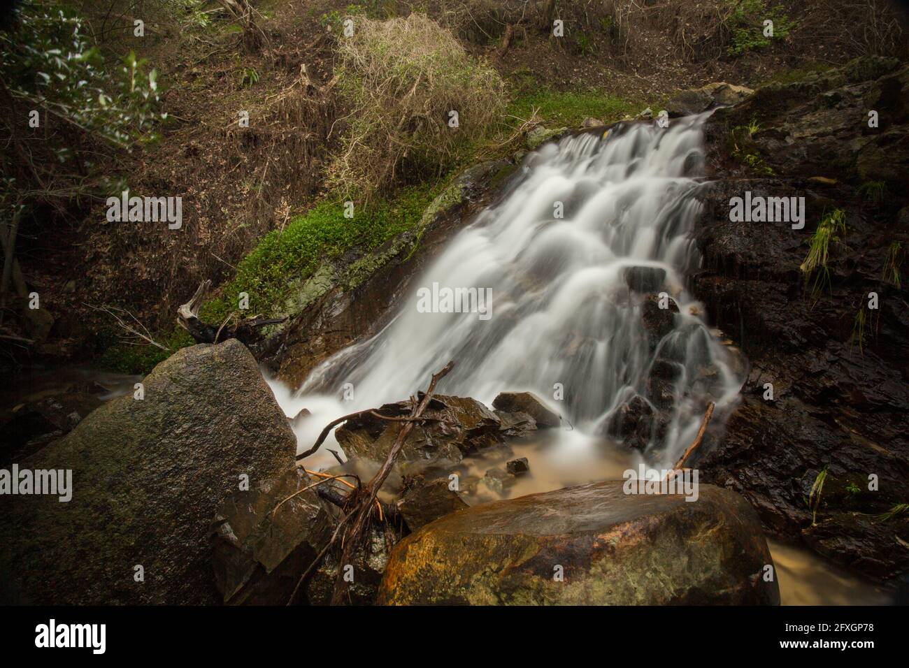 A cascading waterfall in a mountain in the Paarl Region of the Western Cape, South Africa. Water is a scarce resource in the area. Stock Photo