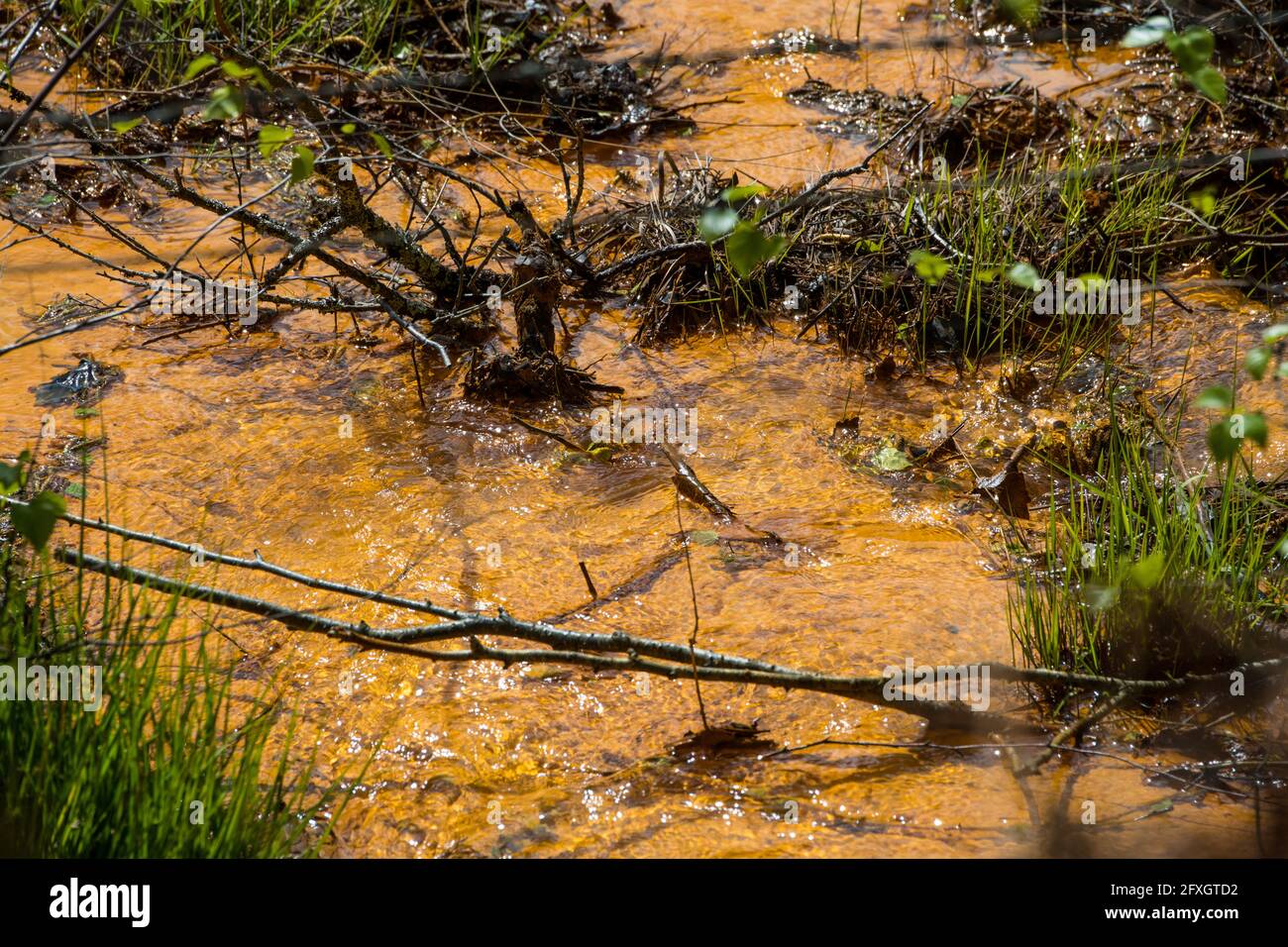 Water pollution in a river flowing from an old disused lead mine in Wales after passing through
