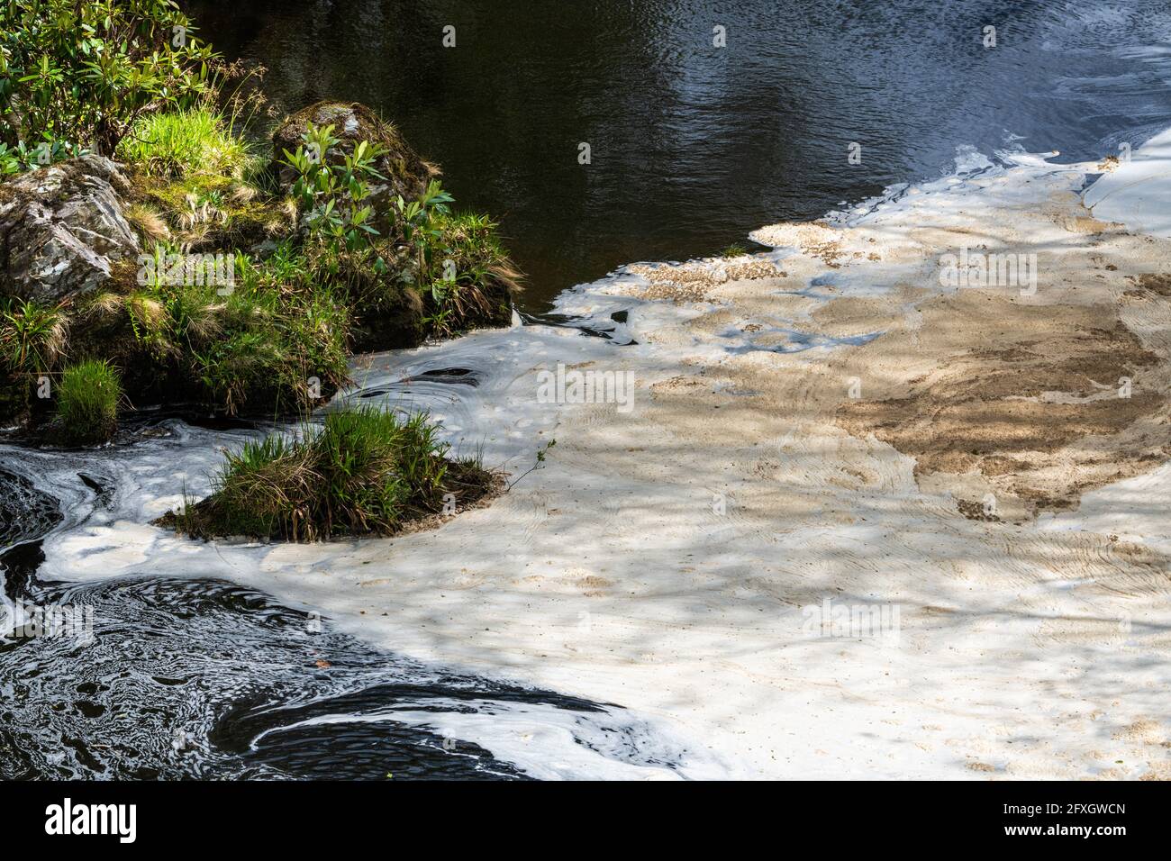 Water pollution in a river flowing from an old disused lead mine in Wales after passing through