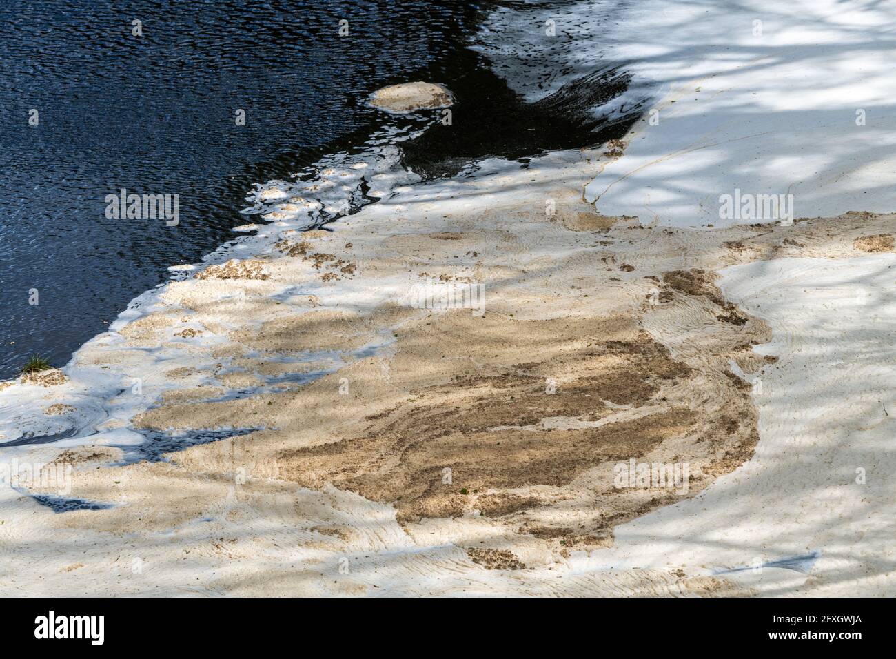 Water pollution in a river flowing from an old disused lead mine in Wales after passing through