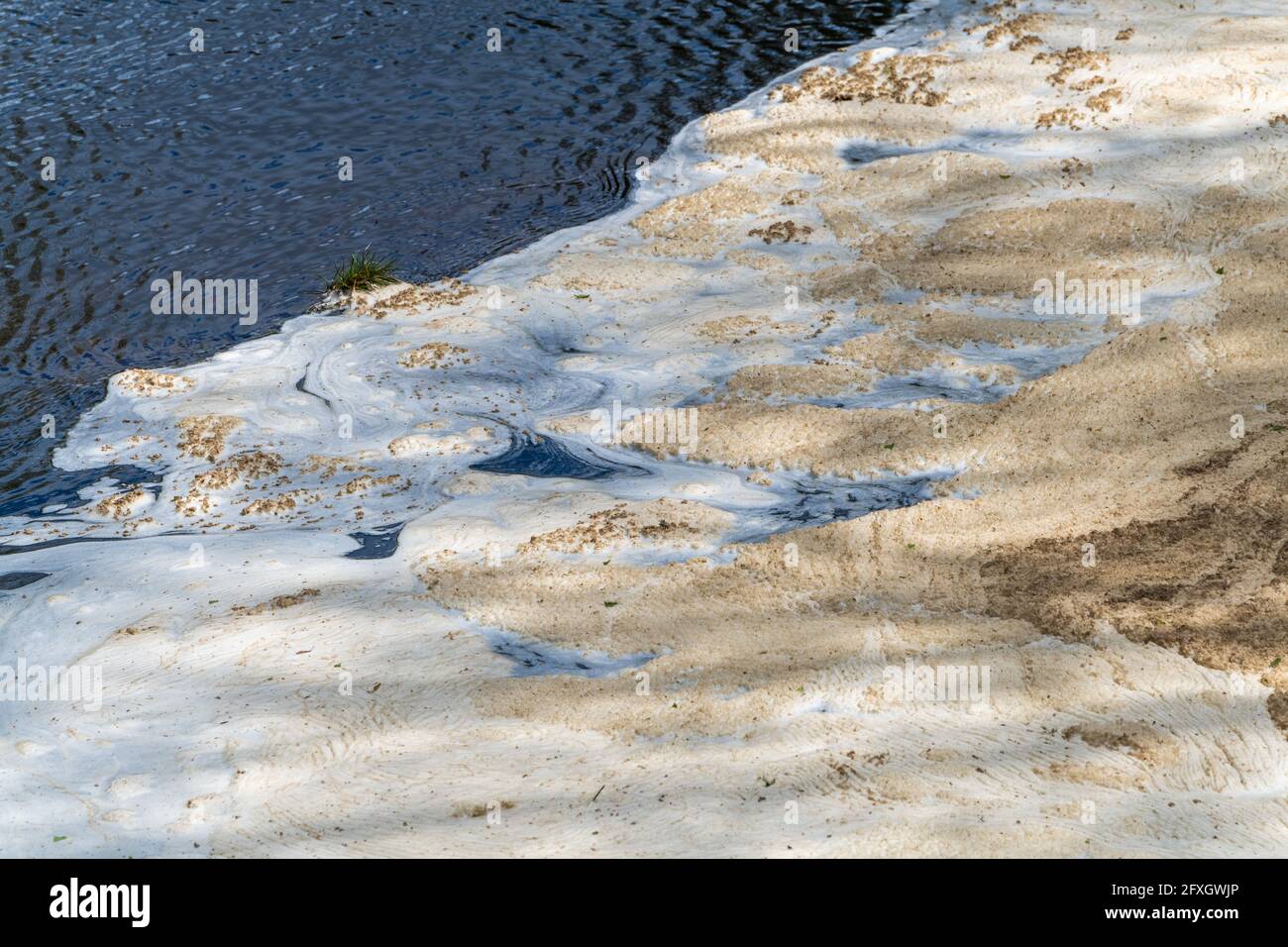 Water pollution in a river flowing from an old disused lead mine in Wales after passing through