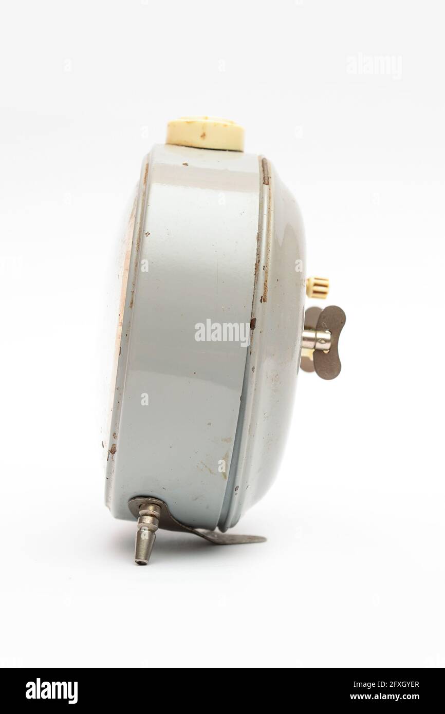 Old mechanical alarm clock on white background Stock Photo - Alamy