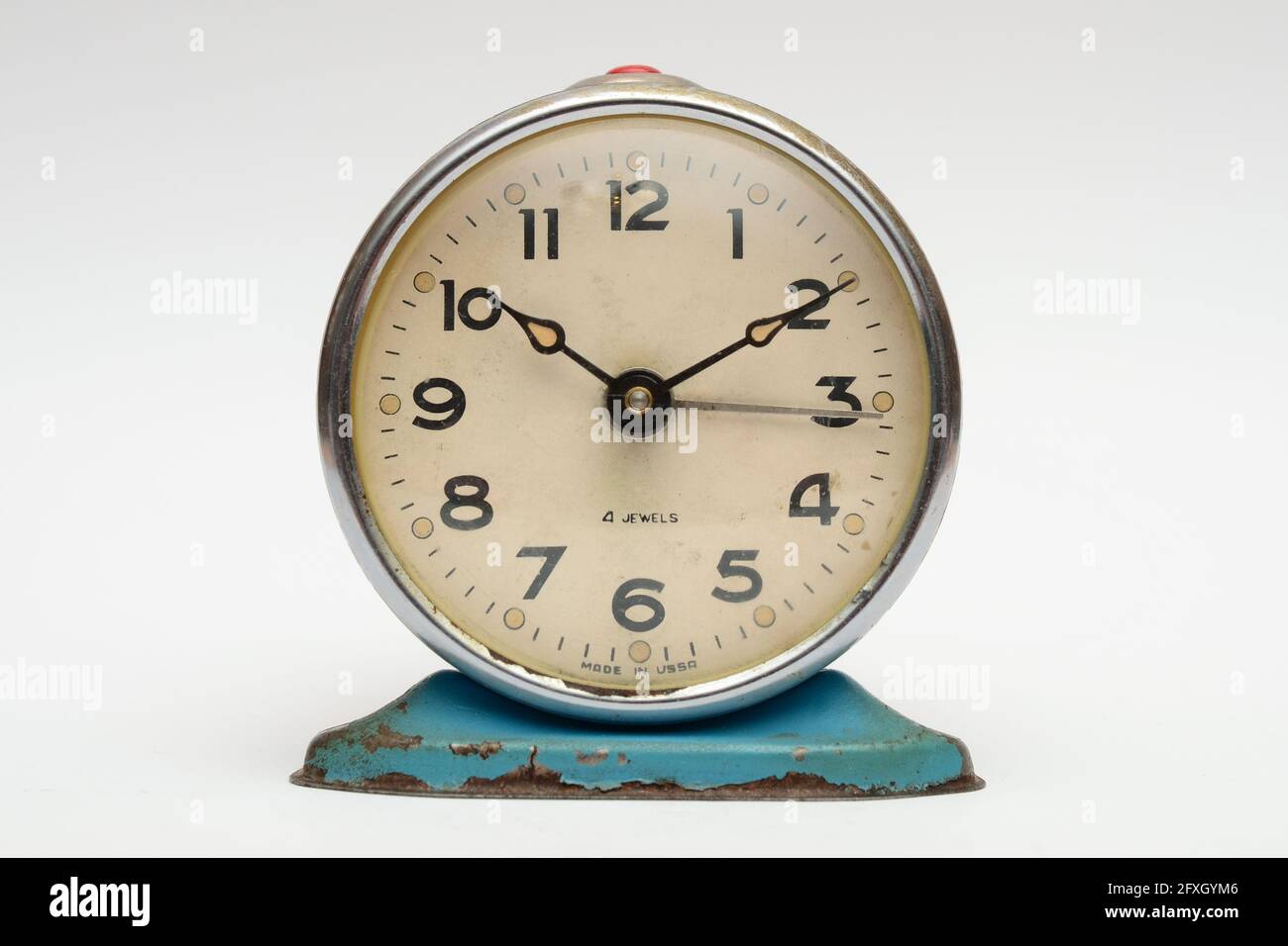 Old mechanical alarm clock on white background Stock Photo - Alamy