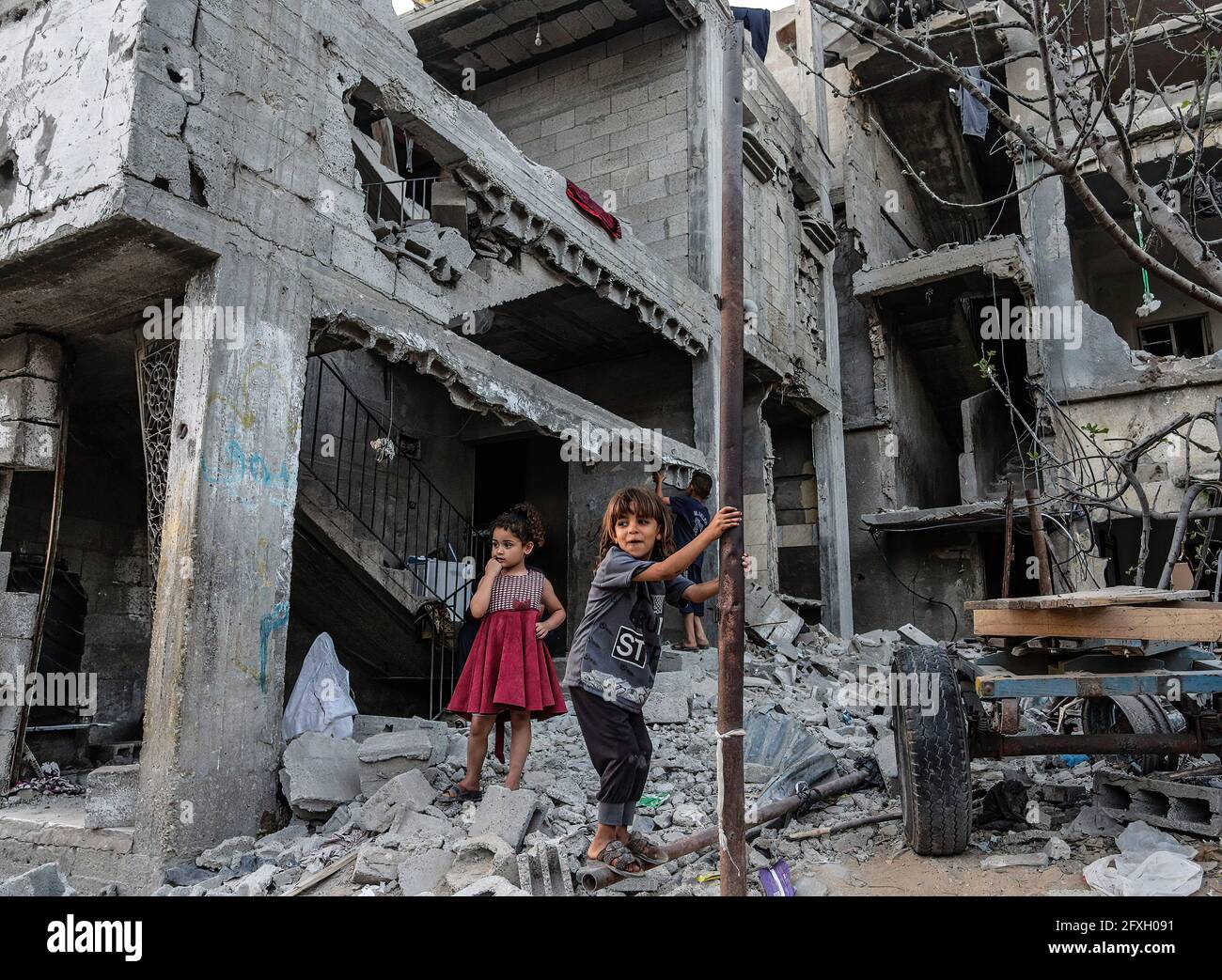 Palestinian children play in front of their destroyed homes in Beit ...