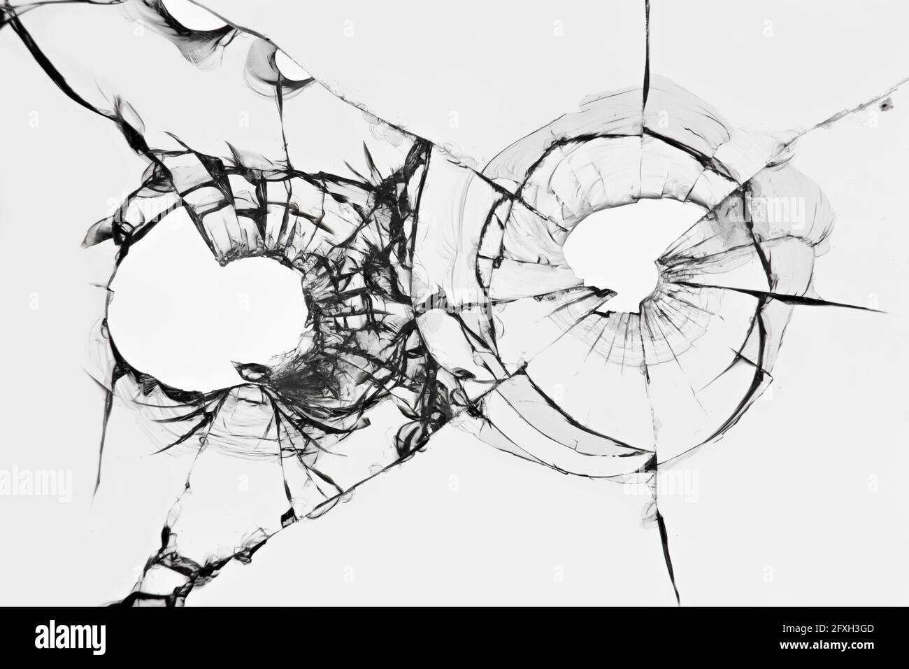 The effect of broken glass from a shot. Holes from pistol bullets in the windshield of a car. Stock Photo