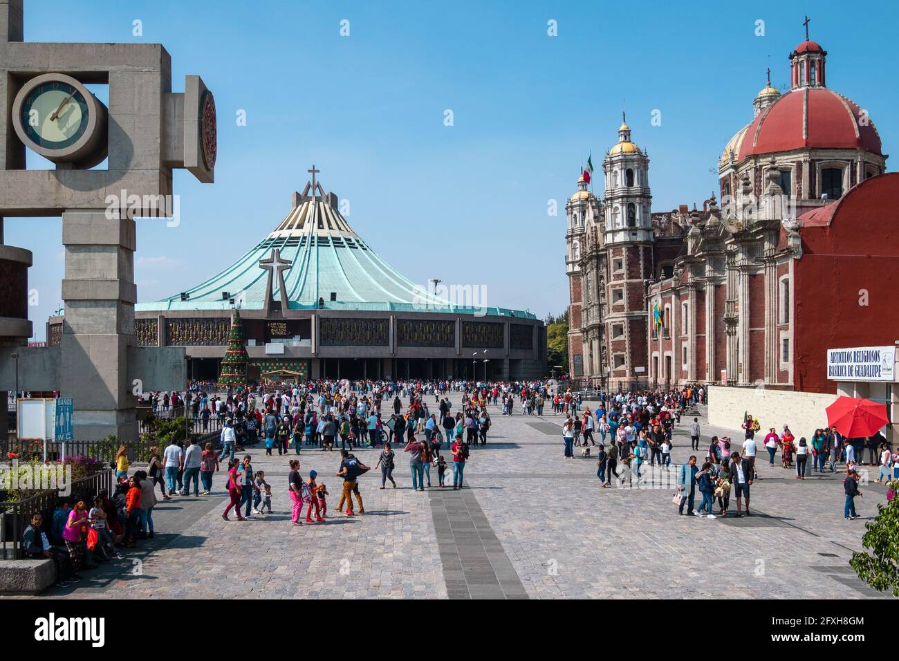 Worshippers at historical landmark Basilica of Our Lady of Guadalupe on a sunny day in Mexico City, Mexico. Stock Photo