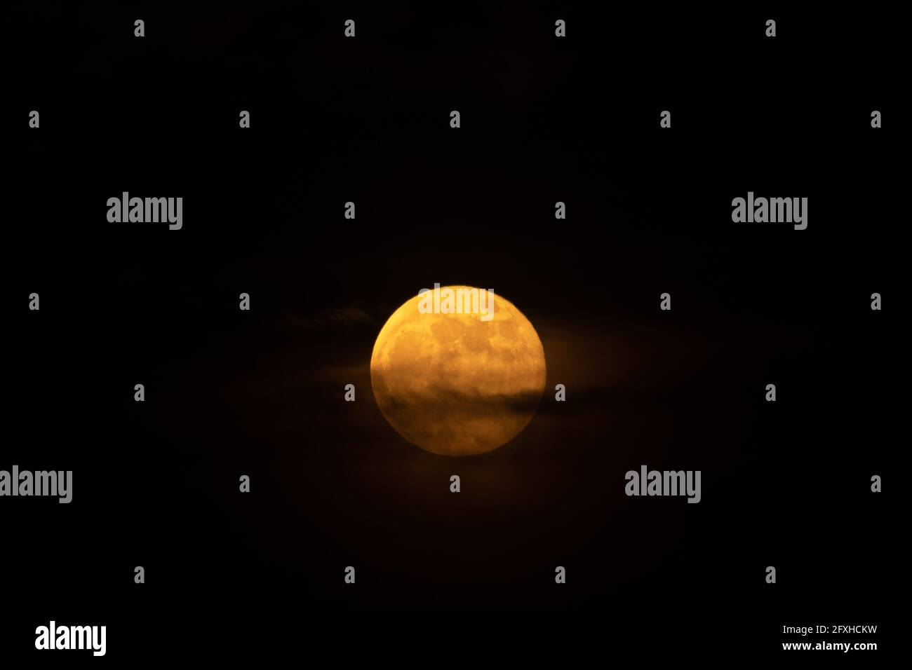 Orange full moon on black night sky. Blood moon. Flower moon. Lunar eclipse. Astronomy and astronomical concept. Stock Photo
